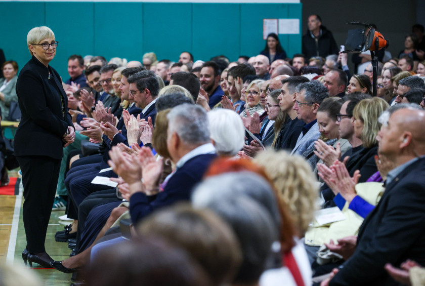 Predsednica stoji v prvi vrsti pred zbranimi na prireditvi.