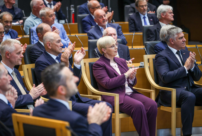 Predsednica sedi na seji Državnega zbora in ploska.
